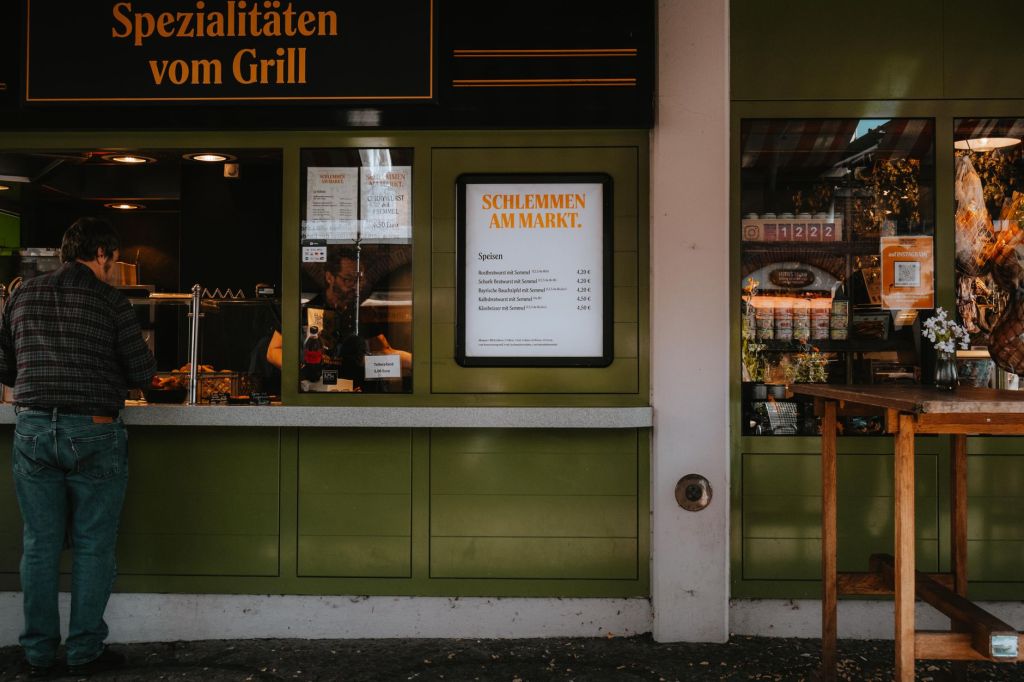 Restaurant interior with a menu board listing prices