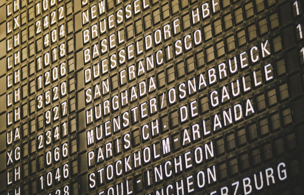 Airport departure board listing international destinations